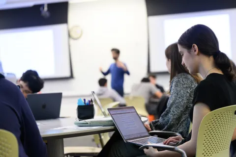 Student on laptop in a classroom